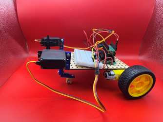Early bridge robot prototype with basic servo arm, no obstacle-clearing wheel